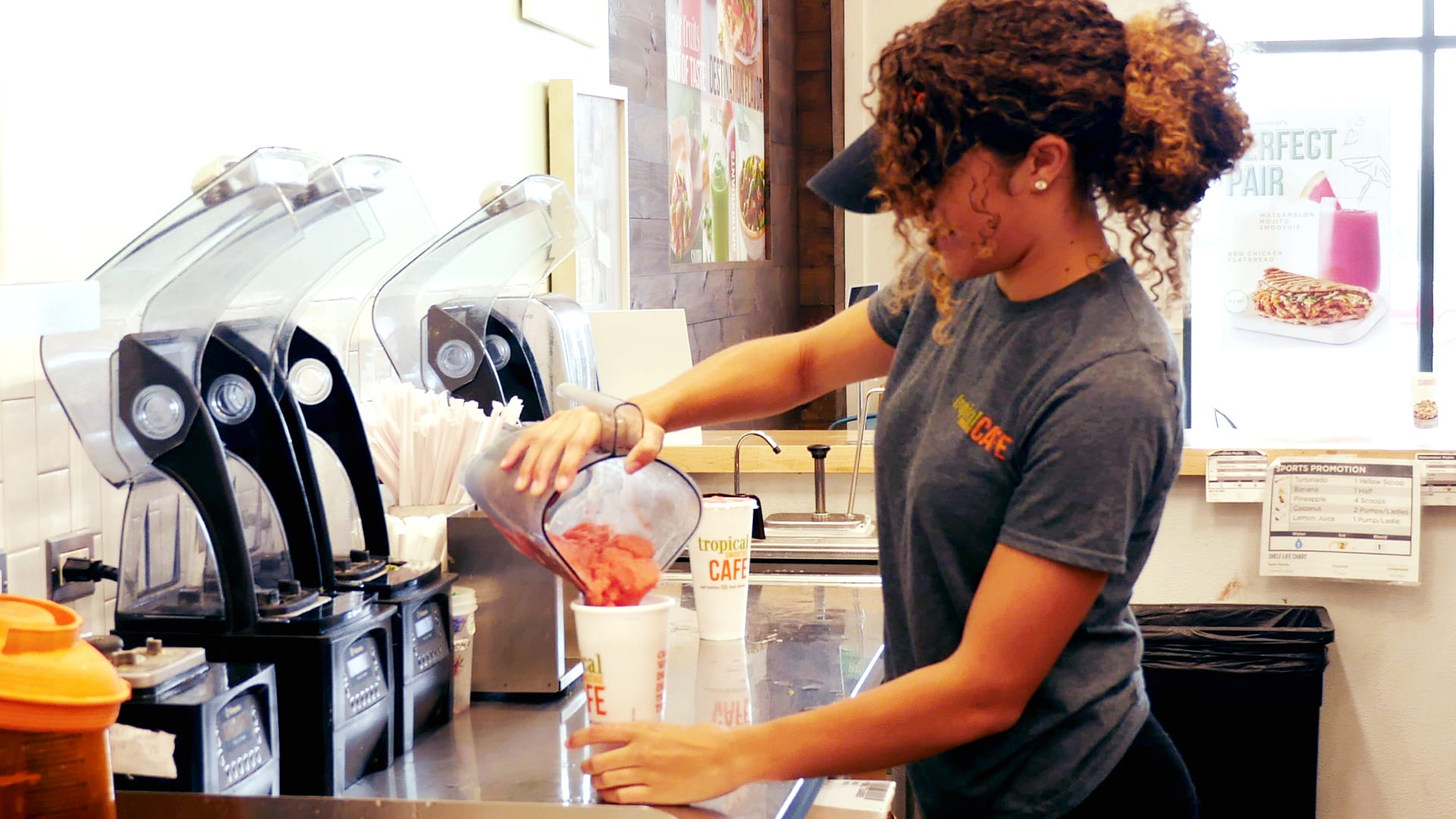 Worker pouring a smoothie at Tropical Smoothie Cafe
