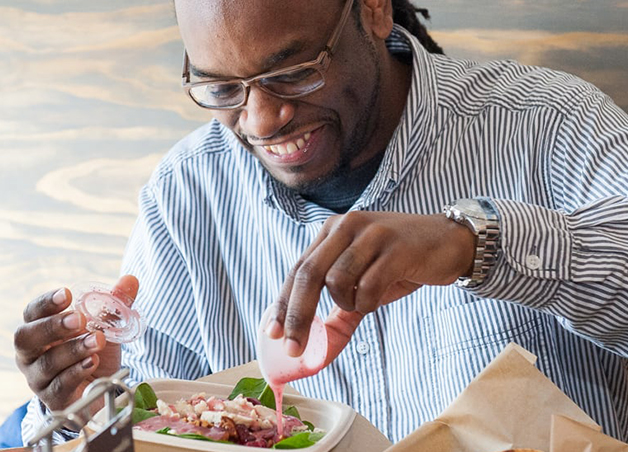 Customer enjoying food at a Tropical Smoothie Cafe