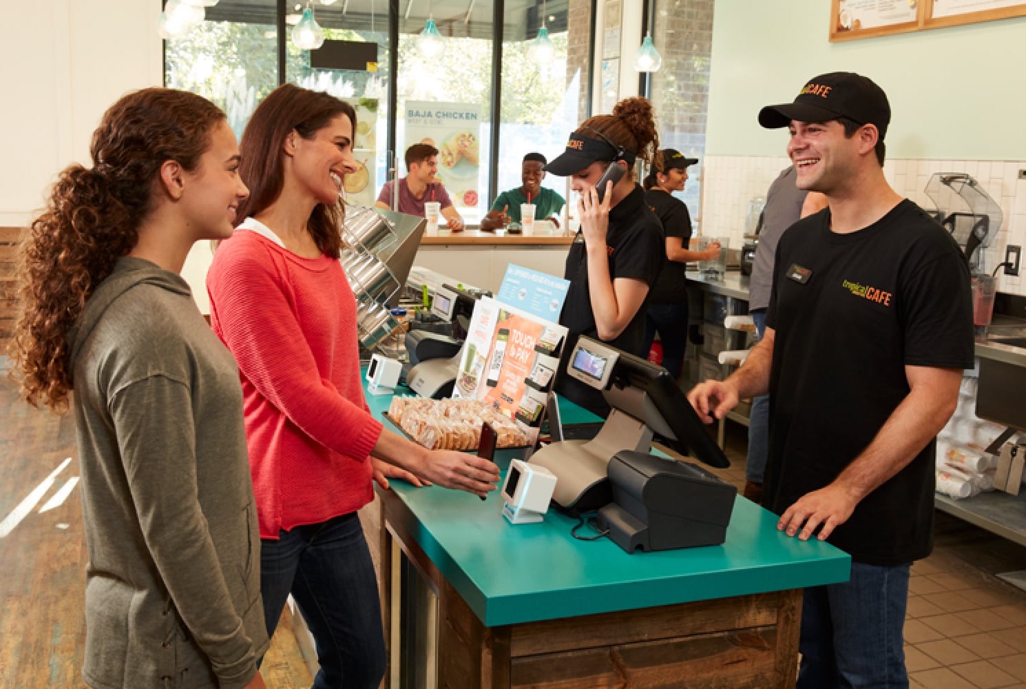 Happy customer and staff at a Tropical Smoothie Cafe