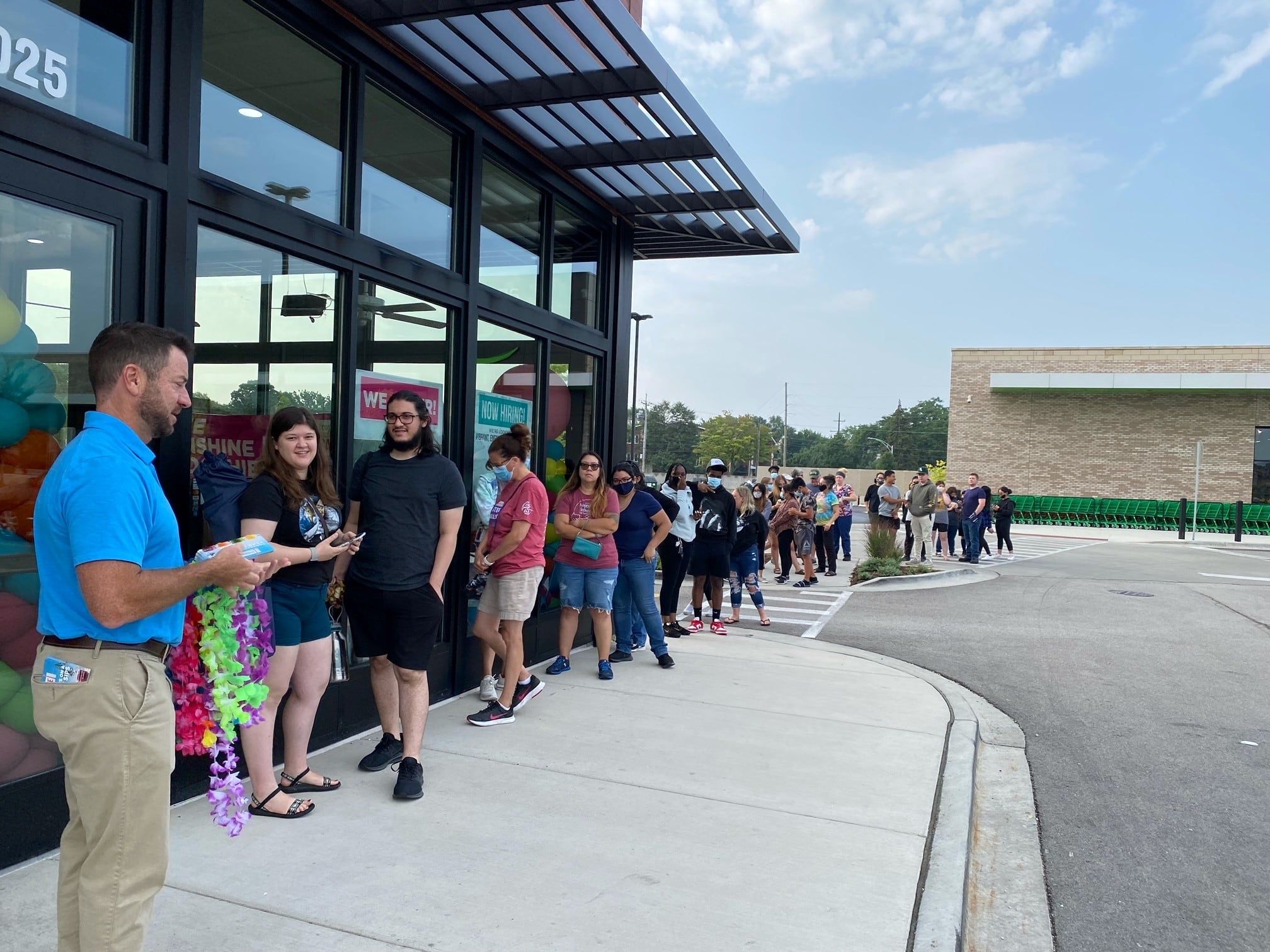Guests waiting in line for a free smoothie at Grand Opening