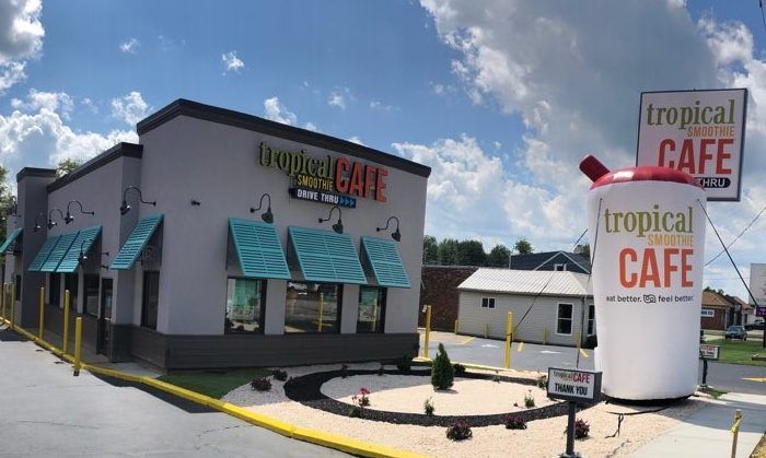 Giant inflatable smoothie cup outside of a Tropical Smoothie building