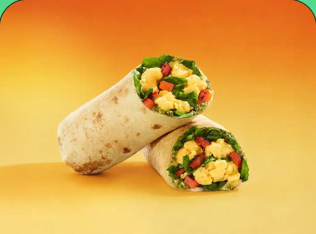 Two breakfast wraps filled with eggs and vegetables